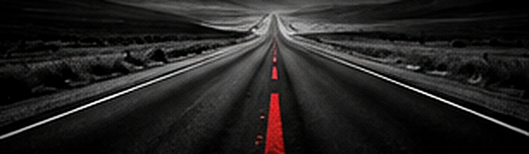 An empty road running dead straight to the horizon, a red line down the centre.