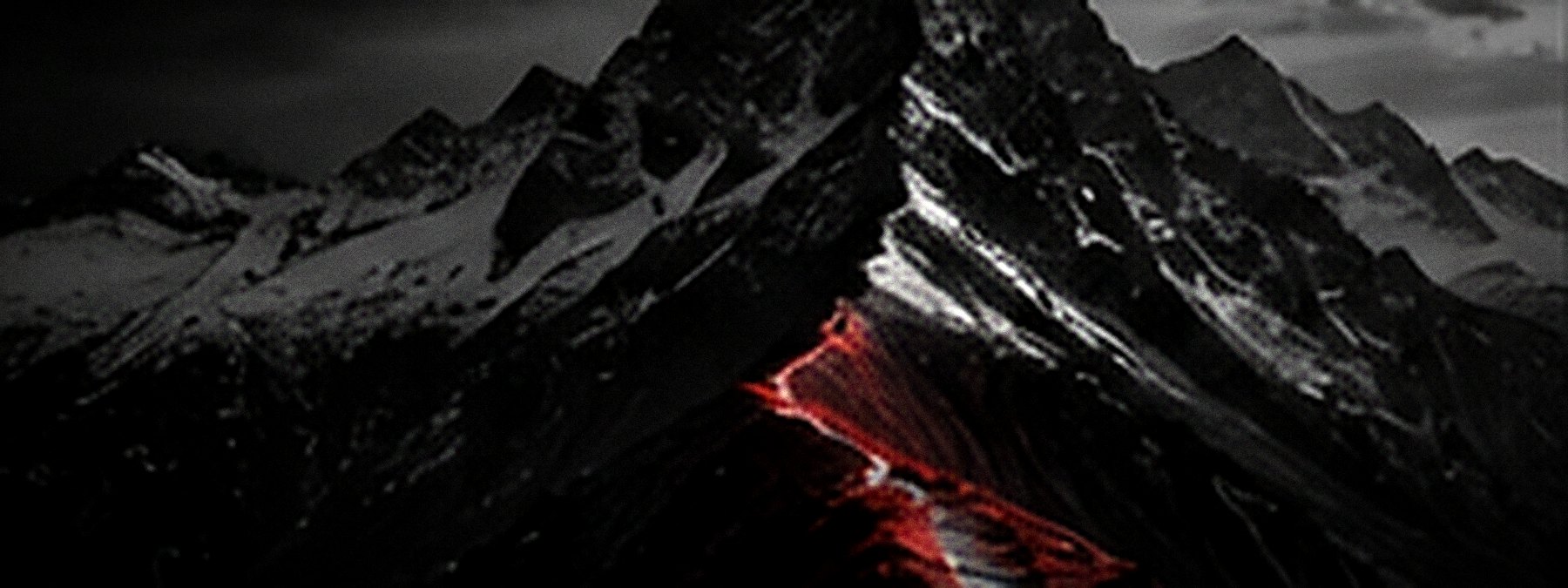 A dark mountain range with a glowing red seam cut down its face.